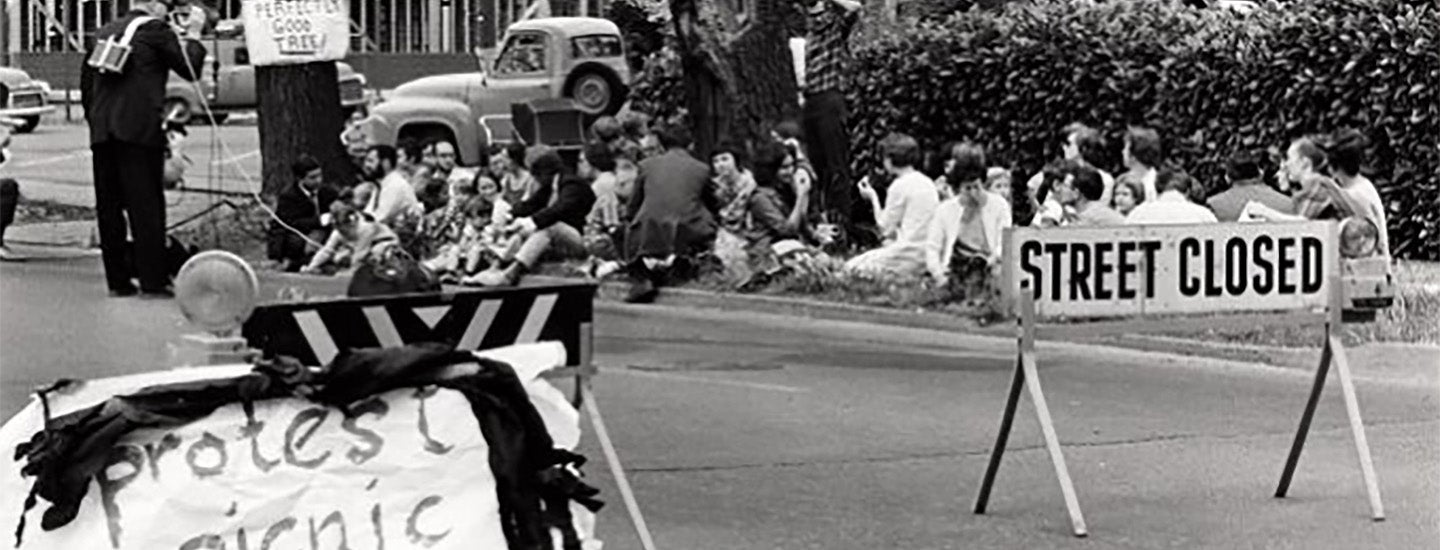 Students stage a "protest picnic" along a Eugene street